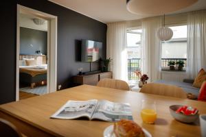 a room with a table and a bedroom with a bed at Guestly Homes - 3BR Superior Apartment in Boden
