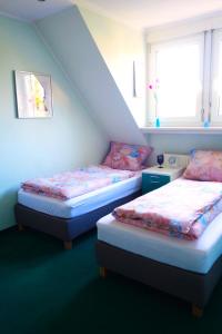 a room with two beds and a window at Aparthotel Messe Flughafen in Düsseldorf