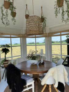 a dining room with two dogs sitting around a table at By Mosk in Engelum +32 photos