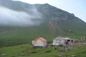 a group of tents on a hill with a mountain at Outdoor Adventures Camp Ratti Gali Lake in Shardi