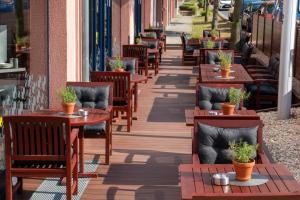 a row of tables and chairs on a sidewalk at Best Western Premier Airporthotel Berlin in Schönefeld