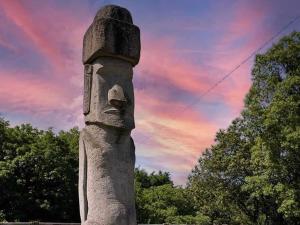 a statue of a head with a sunset in the background at La Peonia in Vitorchiano