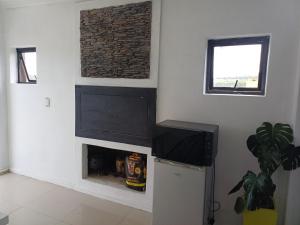 a living room with a fireplace and a tv at On 36 Neethlingshof in Cape Town