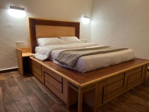 a bedroom with a large bed on a wooden platform at Fly Fishes Hotel in Saint-Louis