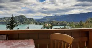 a balcony with a view of a lake and mountains at Apartment Milly in Bled +11 photos