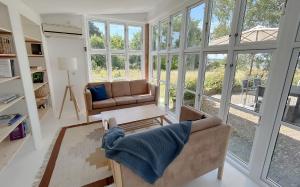 a living room with a couch and a table at Sunset over water, 50 mins from Copenhagen in Skibby