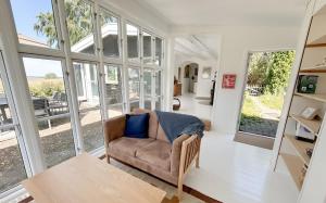 a living room with a couch and large windows at Sunset over water, 50 mins from Copenhagen in Skibby +49 photos