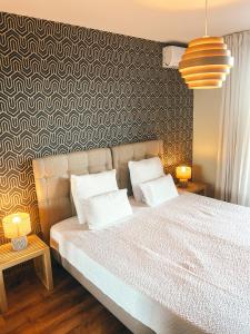 a bedroom with a large bed with two pillows at La Terrasse de l'Esterel in Mandelieu-La Napoule +10 photos