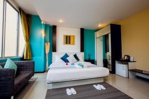 a bedroom with a large bed and a couch at Anchor Boutique House in Patong Beach