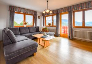 a living room with a couch and a table at Hansjörgenhof Bioland-Hof in Schiltach