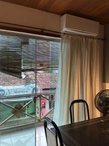 a dining room table with a view of a balcony at Pituba Vile - Apartamento Mandala in Itacaré +16 photos