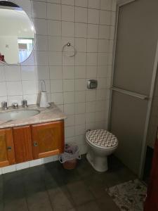 a bathroom with a toilet and a sink and a mirror at Romas House Hospedagem Itu in Itu +19 photos