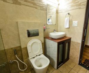 a bathroom with a toilet and a sink at Vista Valley Stay, Luxury 3 BHK Villa Kangra, Dharamshala in Dharamshala +53 photos