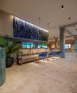 a waiting room with a couch and chairs in a building at Hotel Agua del Desierto in Calama +15 photos