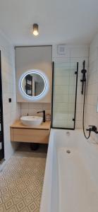 a bathroom with a sink and a mirror at Apartment Mitis in Hodonín +18 photos