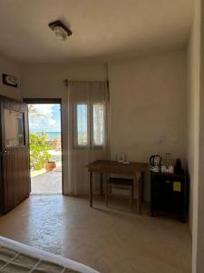 an empty room with a table and a door to a patio at La Conchita Tulum in Tulum