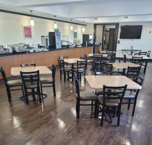 a dining room filled with tables and chairs at The Kanata Bonnyville in Bonnyville