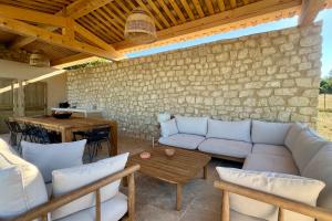 a living room with a couch and a table at LE Mas Jas magnificent Mas Provençal - Lauris in Lauris