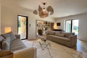 a living room with a couch and a table at LE Mas Jas magnificent Mas Provençal - Lauris in Lauris