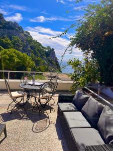 un patio con divano, tavolo e sedie. di Villa La Perla Capri a Capri Altre 37 foto