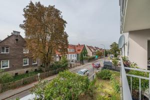 a view from a balcony of a street with houses at Apartament Emily Brzeźno in Zaspa
