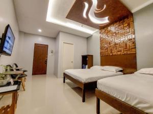 Postel nebo postele na pokoji v ubytování JCzar Suites + 17 fotografií