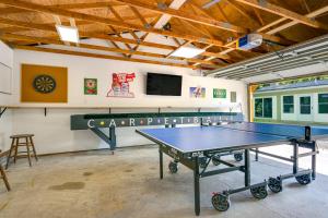 a ping pong room with a ping pong table at Houghton Lake Cottage Escape with Patio! in Houghton Lake