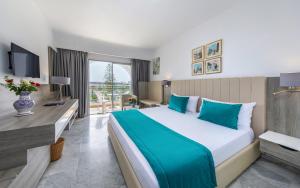 a hotel room with a bed and a desk at Hotel Marhaba Beach in Sousse