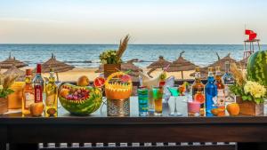 a table with drinks and fruit on the beach at Marhaba Royal Salem - Family Only in Sousse