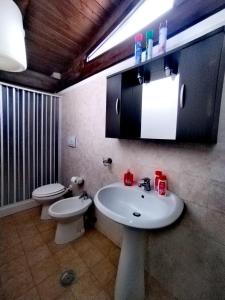 a bathroom with a sink and a toilet at Holiday Residence in Casamassima +129 photos