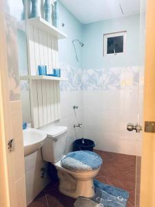 a bathroom with a toilet and a sink at Butuan Arbnb in Somilihon