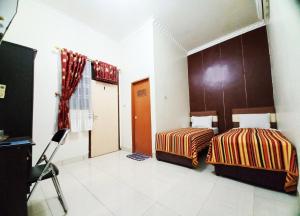 Guest House Syariah GS Sakinah, Kota Metro客房内的一张或多张床位