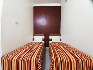 Guest House Syariah GS Sakinah, Kota Metro客房内的一张或多张床位