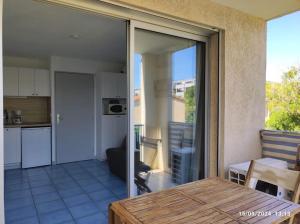 a kitchen and a living room with a sliding glass door at Studio cabine tout équipé in Le Lavandou