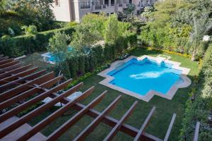 an overhead view of a swimming pool in a yard at 4 master bedrooms villa with private swimming pool in Cairo +9 photos