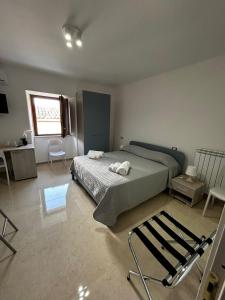 a bedroom with a bed and a desk and a window at La Spiga in Gangi +15 photos