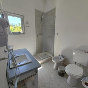 a bathroom with a toilet and a sink and a shower at Sol de montaña, Bariloche. in San Carlos de Bariloche +92 photos