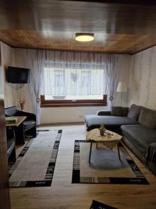 a living room with a couch and a table at Ferienhaus Heimes in Klotten