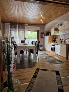 a kitchen and dining room with a table and chairs at Ferienhaus Heimes in Klotten