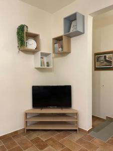 a living room with a flat screen tv on a wall at Casa DOLCE VITA centro di Pistoia in Pistoia