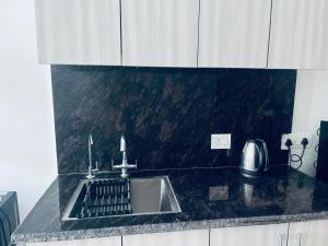 a kitchen with a sink and a counter top at Royal orbit studio in Ghaziabad