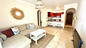 a living room with a couch and a table at Bohemian Dreams Los Abrigos by Deihu Experiences in Granadilla de Abona
