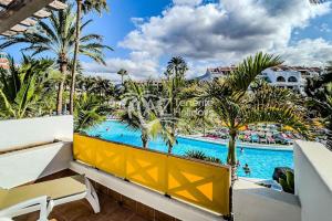a view of the pool from the balcony of a resort at Fabulous beach house in Las Americas in Playa de las Americas