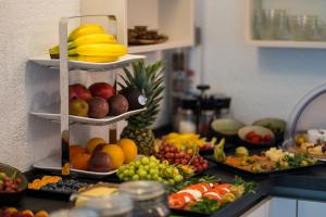 a bunch of fruits and vegetables on a kitchen counter at B&B Outlet Hotel - Metzingen - Bad Urach - Free Parking in Dettingen an der Erms
