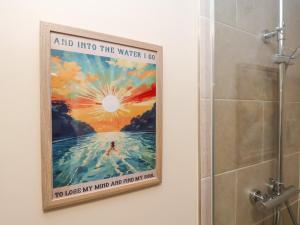 a poster in a bathroom with a shower at Crossing Cottage in Whitby +23 photos