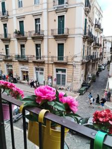 a bunch of pink flowers in a pot on a balcony at La Palazzina dei Fiori in Bari +14 photos