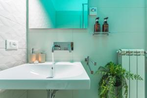 a bathroom with a white sink and a mirror at San Pietro Panoramic View in Rome +40 photos