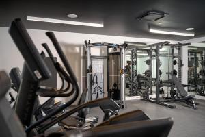 a gym with a bunch of cardio machines in it at Grand Hotel View in Postira