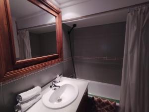 een badkamer met een wastafel, een spiegel en een bad bij Dornajo Elite in Sierra Nevada +15 foto's