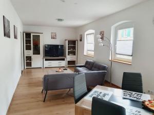 a living room with a couch and a table at 115qm Wohnparadies in Herbolzheim